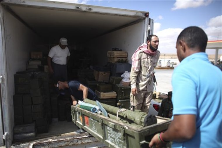 Rebels unload ammunition from a truck in Wish Tata, Libya, Friday, Sept. 9, 2011. Libya's rebels have surrounded the ousted dictator Moammar Gadhafi, and it is only a matter of time until he is captured or killed, a spokesman for Tripoli's new military council said Wednesday. (AP Photo/Alexandre Meneghini)